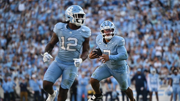 Nov 22, 2025; Chapel Hill, North Carolina, USA; North Carolina Tar Heels quarterback Gio Lopez (7) rushes around the end during the first half against the Duke Blue Devils at Kenan Stadium. Mandatory Credit: William Howard-Imagn Images Nov 22, 2025; Chapel Hill, North Carolina, USA; North Carolina Tar Heels quarterback Gio Lopez (7) rushes around the end during the first half against the Duke Blue Devils at Kenan Stadium. Mandatory Credit: William Howard-Imagn Images