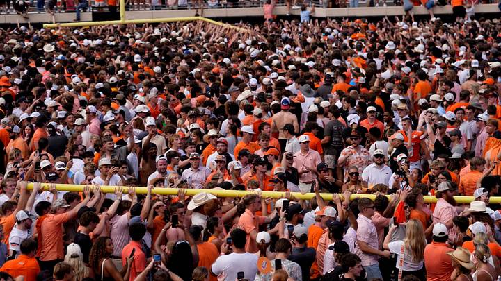 Fans carry the goal post following the college football game between the Oklahoma State Cowboys and the Oregon Ducks.