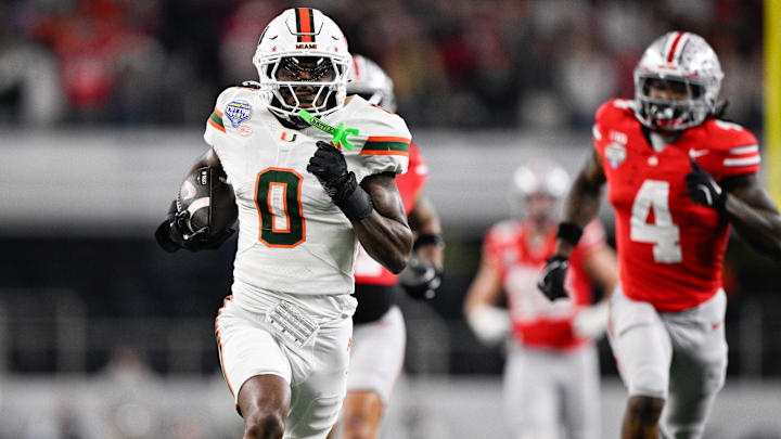 Dec 31, 2025; Arlington, TX, USA; Miami Hurricanes defensive back Keionte Scott (0) runs the ball for a touchdown after an interception against the Ohio State Buckeyes in the second quarter during the 2025 Cotton Bowl and quarterfinal game of the College Football Playoff at AT&T Stadium. Mandatory Credit: Jerome Miron-Imagn Images