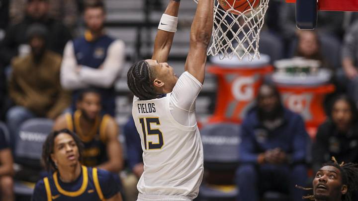 Dec 3, 2025; Morgantown, West Virginia, USA; West Virginia Mountaineers forward Jackson Fields (15) dunks during the first half against the Coppin State Eagles at Hope Coliseum. Mandatory Credit: Ben Queen-Imagn Images