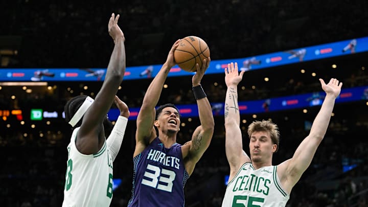 Apr 11, 2025; Boston, Massachusetts, USA; Charlotte Hornets guard Jaylen Sims (33) shoots against Boston Celtics center Neemias Queta (88) and forward Baylor Scheierman (55) during the second half at TD Garden. Mandatory Credit: Eric Canha-Imagn Images