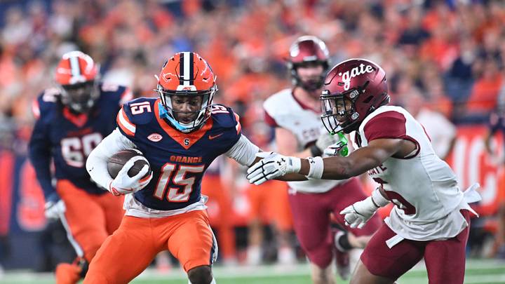 Sep 12, 2025; Syracuse, New York, USA; Syracuse Orange wide receiver Darrell Gill Jr. (15) tries to avoid a tackle by Colgate Raiders defensive back Tymir Wynn (6) in the first quarter at the JMA Wireless Dome. Mandatory Credit: Mark Konezny-Imagn Images Sep 12, 2025; Syracuse, New York, USA; Syracuse Orange wide receiver Darrell Gill Jr. (15) tries to avoid a tackle by Colgate Raiders defensive back Tymir Wynn (6) in the first quarter at the JMA Wireless Dome. Mandatory Credit: Mark Konezny-Imagn Images