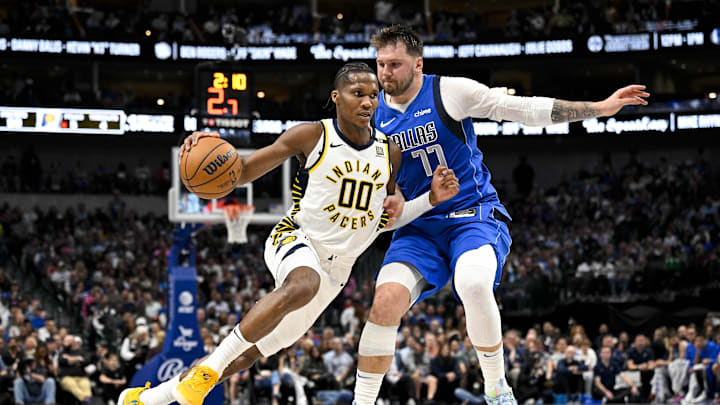 Mar 5, 2024; Dallas, Texas, USA; Indiana Pacers guard Bennedict Mathurin (00) brings the ball up court past Dallas Mavericks guard Luka Doncic (77) during the second half at the American Airlines Center. Mandatory Credit: Jerome Miron-USA TODAY Sports