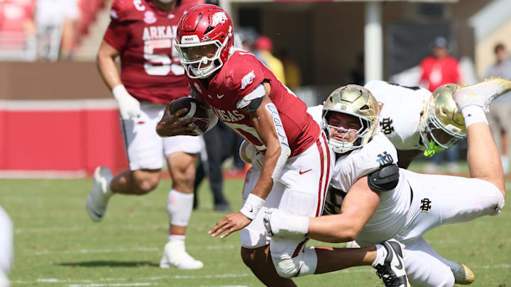 Sep 27, 2025; Fayetteville, Arkansas, USA; Arkansas Razorbacks quarterback Taylen Green (10) is tackled by Notre Dame Fighting Irish defensive lineman Elijah Hughes (56) during the second half at Donald W. Reynolds Razorback Stadium. Notre Dame won 56-13. Mandatory Credit: Nelson Chenault-Imagn Images