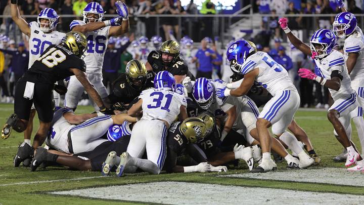 Oct 24, 2026; Orlando, Florida, USA; The Brigham Young Cougars defense stops Central Florida Knights quarterback Keyone Jenkins (12) from scoring late in the fourth quarter at Acrisure Bounce House. Mandatory Credit: Mike Watters-Imagn Images Oct 24, 2026; Orlando, Florida, USA; The Brigham Young Cougars defense stops Central Florida Knights quarterback Keyone Jenkins (12) from scoring late in the fourth quarter at Acrisure Bounce House. Mandatory Credit: Mike Watters-Imagn Images
