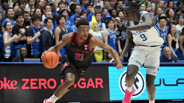 Feb 15, 2025; Durham, North Carolina, USA; Stanford Cardinal guard Jaylen Blakes (21) drives the ball under pressure from Duke Blue Devils center Khaman Maluach (9) during the first half at Cameron Indoor Stadium. Mandatory Credit: Zachary Taft-Imagn Images Feb 15, 2025; Durham, North Carolina, USA; Stanford Cardinal guard Jaylen Blakes (21) drives the ball under pressure from Duke Blue Devils center Khaman Maluach (9) during the first half at Cameron Indoor Stadium. Mandatory Credit: Zachary Taft-Imagn Images