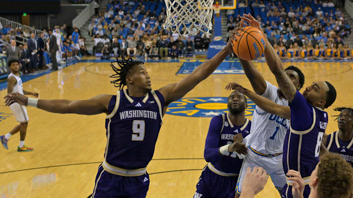  Huskies guard Wesley Yates III (9) and  forward Bryson Tucker (8) battle UCLA's Xavier Booker (1) for a rebound. 