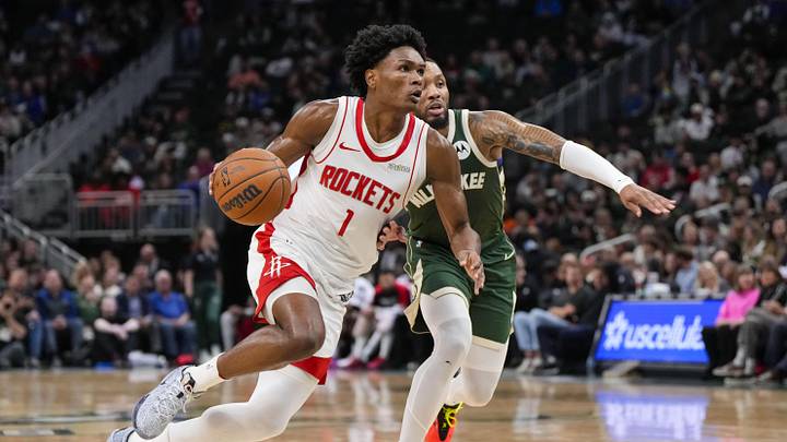 Nov 18, 2024; Milwaukee, Wisconsin, USA;  Houston Rockets guard Amen Thompson (1) drives for the basket against Milwaukee Bucks guard Damian Lillard (0) during the second quarter at Fiserv Forum. Mandatory Credit: Jeff Hanisch-Imagn Images