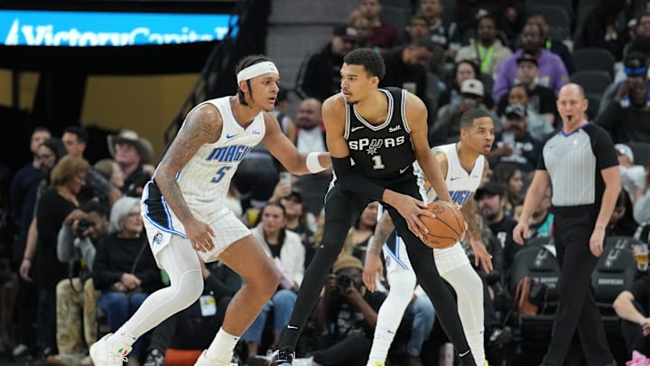Jan 31, 2024; San Antonio, Texas, USA;  San Antonio Spurs center Victor Wembanyama (1) looks to pass in front of Orlando Magic forward Paolo Banchero (5) in the second half at Frost Bank Center. Mandatory Credit: Daniel Dunn-Imagn Images