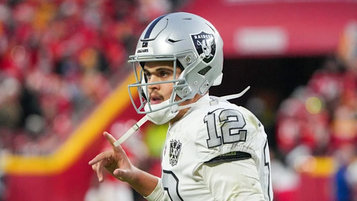 Nov 29, 2024; Kansas City, Missouri, USA; Las Vegas Raiders quarterback Aidan O'Connell (12) goes to the sidelines after a series the Kansas City Chiefs during the second half at GEHA Field at Arrowhead Stadium. Mandatory Credit: Denny Medley-Imagn Images