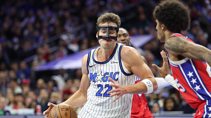 Nov 25, 2025; Philadelphia, Pennsylvania, USA; Orlando Magic forward Franz Wagner (22) drives against Philadelphia 76ers forward Dominick Barlow (25) during the first quarter at Xfinity Mobile Arena. Mandatory Credit: Bill Streicher-Imagn Images