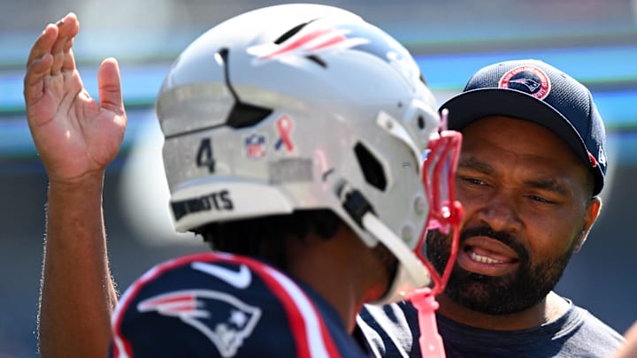 Sep 15, 2024; Foxborough, Massachusetts, USA; New England Patriots head coach Jerod Mayo talks with running back Antonio Gibson (4) before a game against the Seattle Seahawks at Gillette Stadium. Mandatory Credit: Brian Fluharty-Imagn Images