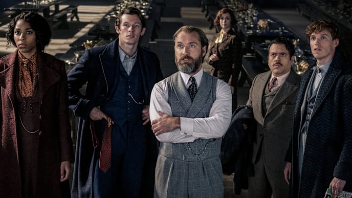(L-R) JESSICA WILLIAMS as Eulalie “Lally” Hicks, CALLUM TURNER as Theseus Scamander, JUDE LAW as Albus Dumbledore, FIONNA GLASCOTT as Minerva McGonagall, DAN FOGLER as Jacob Kowalski and EDDIE REDMAYNE as Newt Scamander in Warner Bros. Pictures' fantasy adventure "FANTASTIC BEASTS: THE SECRETS OF DUMBLEDORE,” a Warner Bros. Pictures release. Photo Credit: Jaap Buitendijk

© 2022 Warner Bros. Ent. All Rights Reserved.
Wizarding World™ Publishing Rights © J.K. Rowling
WIZARDING WORLD and all