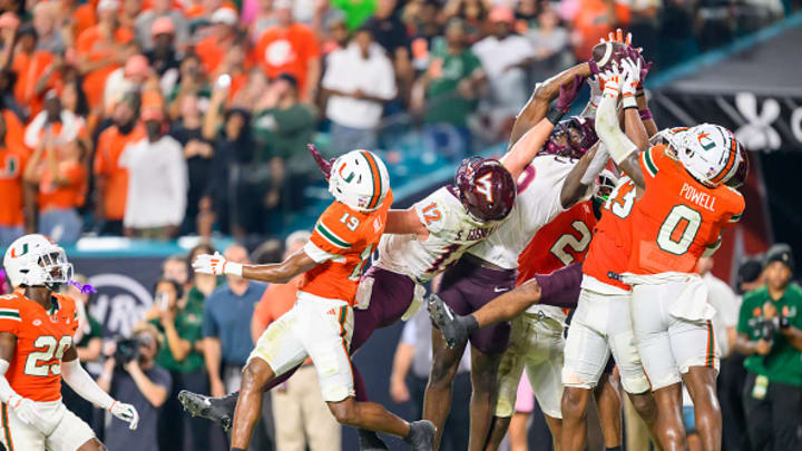 Virginia Tech wide receiver Da'Quan Felton (9) catches the ball in the end zone along with Miami defensive back Tyler Rowe (43) and Miami defensive back Mishael Powell (0) in a controversial play that ended the game between the Virginia Tech Hokies and the Miami Hurricanes on September 27 at Hard Rock Stadium. 