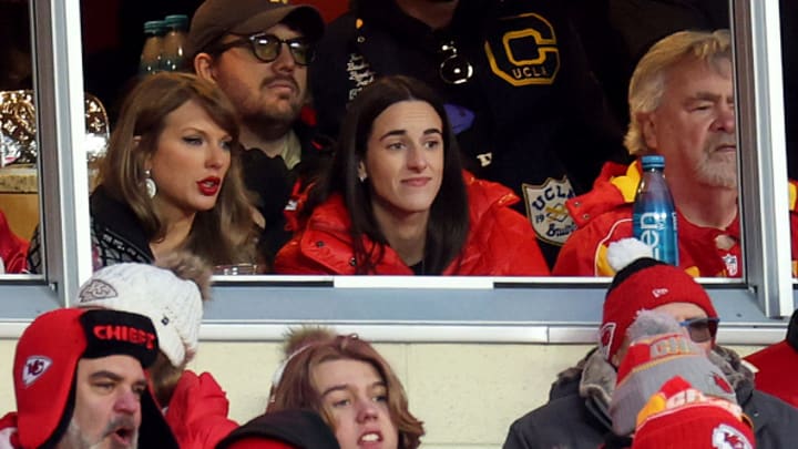 Singer-songwriter Taylor Swift (L) talks with Caitlin Clark (R) of the Indiana Fever during the second half in the AFC Divisional Playoff between the Houston Texans and the Kansas City Chiefs at GEHA Field at Arrowhead Stadium on January 18, 2025 in Kansas City, Missouri. 