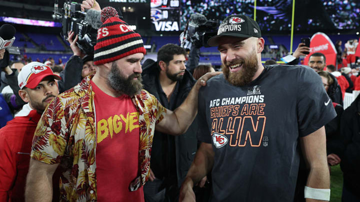Travis Kelce #87 of the Kansas City Chiefs celebrates with his brother Jason Kelce after a 17-10 victory against the Baltimore Ravens in the AFC Championship Game at M&T Bank Stadium on January 28, 2024 in Baltimore, Maryland.
