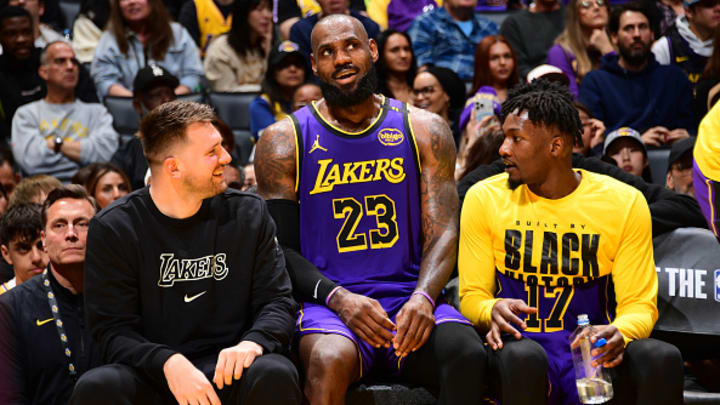 Luka Doncic #77, LeBron James #23, and Dorian Finney-Smith #17 of the Los Angeles Lakers look on during the game against the Golden State Warriors on February 6, 2025 at Crypto.Com Arena in Los Angeles, California.