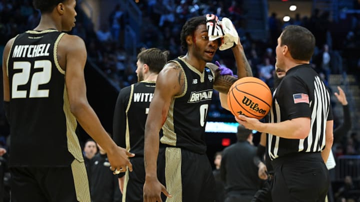 Earl Timberlake speaks with an official after getting bloodied. 