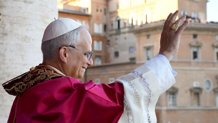 Pope Leo XIV waves to the Vatican crowd upon his election.