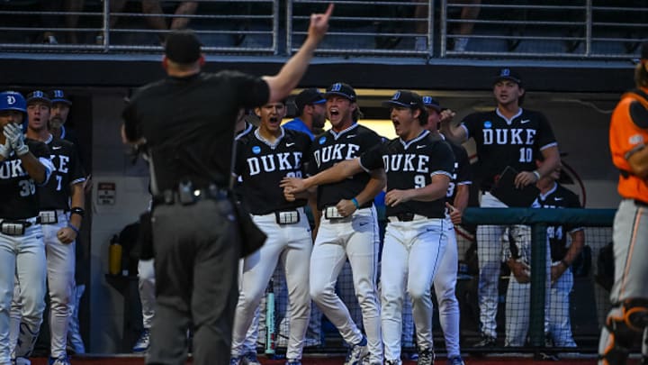 The home plate umpire ejects a Duke player for bringing a hard hat onto the field during the Athens Regional.