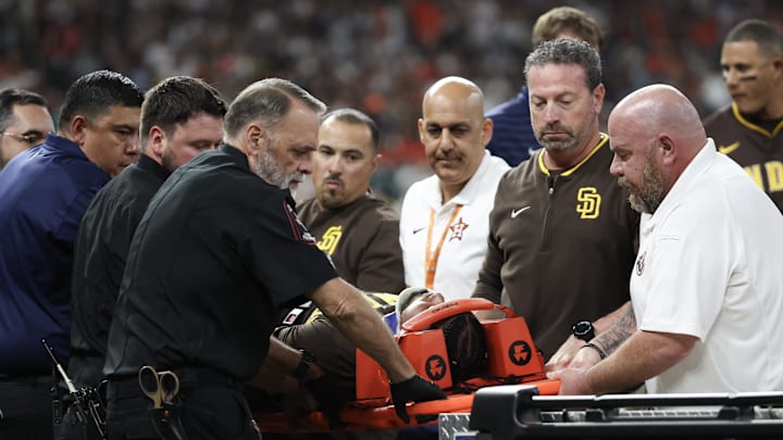 Apr 20, 2025; Houston, Texas, USA;San Diego Padres designated hitter Luis Arraez (4) is carted off the field after he colliding with Houston Astros first baseman Christian Walker (8) (not pictured )on the first base line  in the first inning  at Daikin Park.