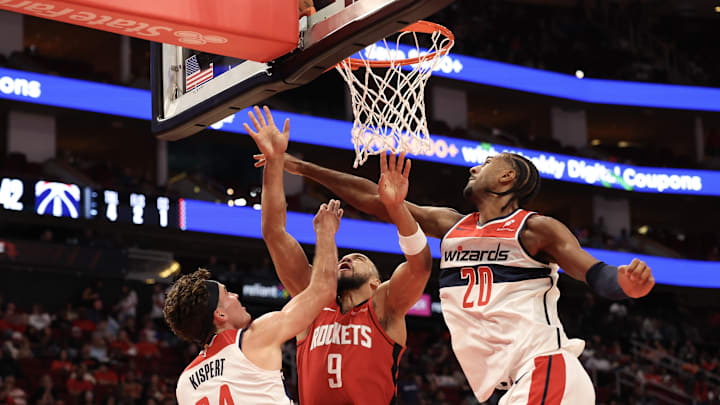 Nov 11, 2024; Houston, Texas, USA;  Washington Wizards forward Corey Kispert (24) hits Houston Rockets forward Dillon Brooks (9) in the face on a rebound in the second quarter at Toyota Center. Mandatory Credit: Thomas Shea-Imagn Images
