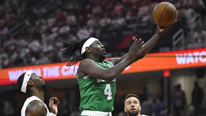 May 13, 2024; Cleveland, Ohio, USA; Boston Celtics guard Jrue Holiday (4) drives to the basket between Cleveland Cavaliers guard Caris LeVert (3) and guard Max Strus (1) in the second quarter of game four of the second round for the 2024 NBA playoffs at Rocket Mortgage FieldHouse. Mandatory Credit: David Richard-Imagn Images