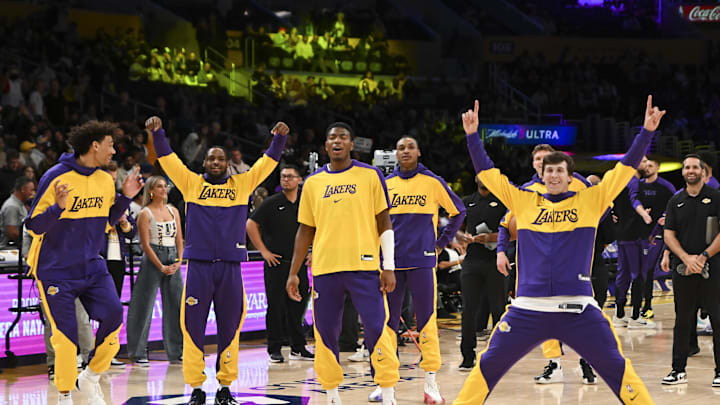 Oct 26, 2024; Los Angeles, California, USA; Los Angeles Lakers guard Austin Reaves (15), forward Rui Hachimura (28), guard Bronny James (9), and other teammates during warm-ups against the Sacramento Kings at Crypto.com Arena. Mandatory Credit: Jonathan Hui-Imagn Images