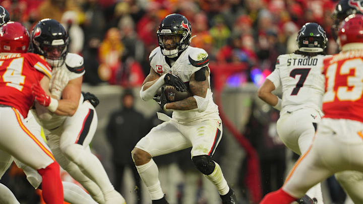 Jan 18, 2025; Kansas City, Missouri, USA; Houston Texans running back Joe Mixon (28) runs the ball against the Kansas City Chiefs during the third quarter of a 2025 AFC divisional round game at GEHA Field at Arrowhead Stadium. Mandatory Credit: Jay Biggerstaff-Imagn Images