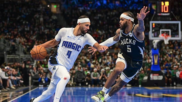 Dec 10, 2024; Milwaukee, Wisconsin, USA; Orlando Magic guard Jalen Suggs (4) drives for the basket against Milwaukee Bucks guard Gary Trent Jr. (5) in the fourth quarter at Fiserv Forum. Mandatory Credit: Benny Sieu-Imagn Images