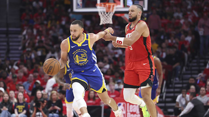 Golden State Warriors guard Stephen Curry (30) controls the ball as Houston Rockets forward Dillon Brooks (9) defends during the second quarter at Toyota Center.
