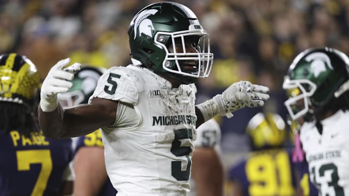 Oct 26, 2024; Ann Arbor, Michigan, USA;  Michigan State Spartans running back Nate Carter (5) celebrates after scoring in the first half against the Michigan Wolverines at Michigan Stadium. Mandatory Credit: Rick Osentoski-Imagn Images