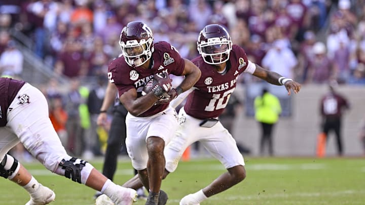 Dec 20, 2025; College Station, TX, USA; Texas A&M Aggies running back Ej Smith (22) runs with the ball during the game between the Aggies and the Hurricanes at Kyle Field. Mandatory Credit: Jerome Miron-Imagn Images