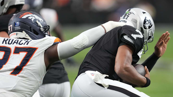 Dec 7, 2025; Paradise, Nevada, USA; Las Vegas Raiders quarterback Geno Smith (7) is sacked by Denver Broncos defensive tackle Malcolm Roach (97) during the first half at Allegiant Stadium. Mandatory Credit: Kirby Lee-Imagn Images Dec 7, 2025; Paradise, Nevada, USA; Las Vegas Raiders quarterback Geno Smith (7) is sacked by Denver Broncos defensive tackle Malcolm Roach (97) during the first half at Allegiant Stadium. Mandatory Credit: Kirby Lee-Imagn Images