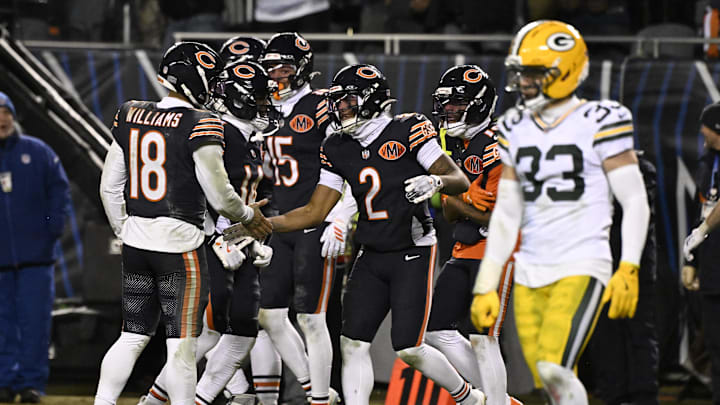 Jan 10, 2026; Chicago, IL, USA;  Chicago Bears quarterback Caleb Williams (18) and wide receiver DJ Moore (2) react after hooking up on the eventually game winning touchdown against the Green Bay Packers during the second half of an NFC Wild Card Round game at Soldier Field. 