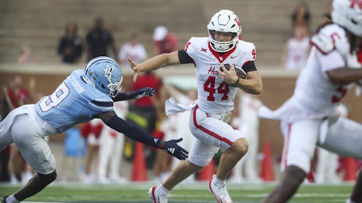 Houston Cougars running back Dean Connors (44) runs with the ball as Rice Owls safety Peyton Stevenson (9) attempts to make a tackle during the first quarter.