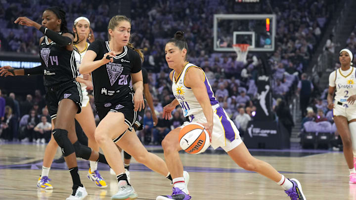 May 16, 2025; San Francisco, California, USA; Los Angeles Sparks guard Kelsey Plum (center) dribbles against Golden State Valkyries guard Kate Martin (20) during the first quarter at Chase Center. Mandatory Credit: Darren Yamashita-Imagn Images