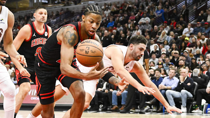 Nov 11, 2024; Chicago, Illinois, USA;  Chicago Bulls forward Dalen Terry (25) and Cleveland Cavaliers forward Georges Niang (20) chase a loose ball during the second half at United Center. Mandatory Credit: Matt Marton-Imagn Images