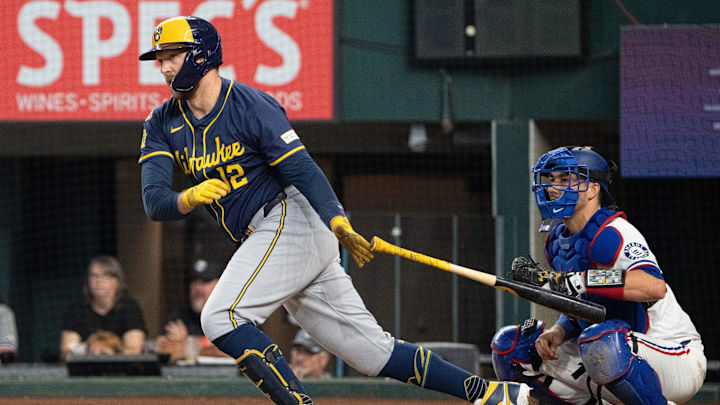 Sep 10, 2025; Arlington, Texas, USA; Milwaukee Brewers first baseman Rhys Hoskins (12) follows through on his RBI single against the Texas Rangers during the sixth inning at Globe Life Field. Mandatory Credit: Jim Cowsert-Imagn Images1