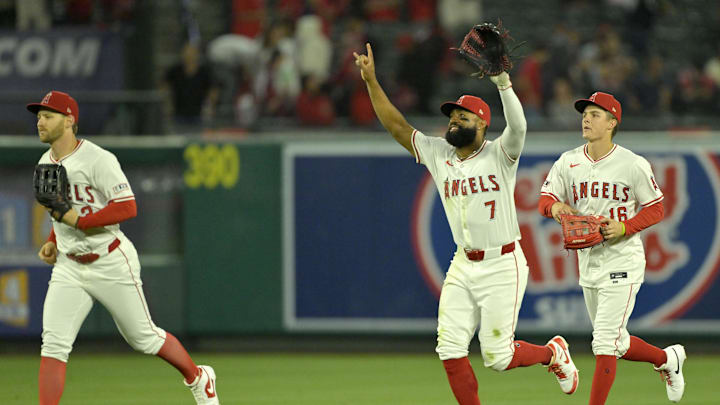 Jun 4, 2024; Anaheim, California, USA;  Los Angeles Angels left fielder Taylor Ward (3), right fielder Jo Adell (7), and center fielder Mickey Moniak (16) celebrate after the final out of ninth inning against the San Diego Padres at Angel Stadium. Mandatory Credit: Jayne Kamin-Oncea-Imagn Images