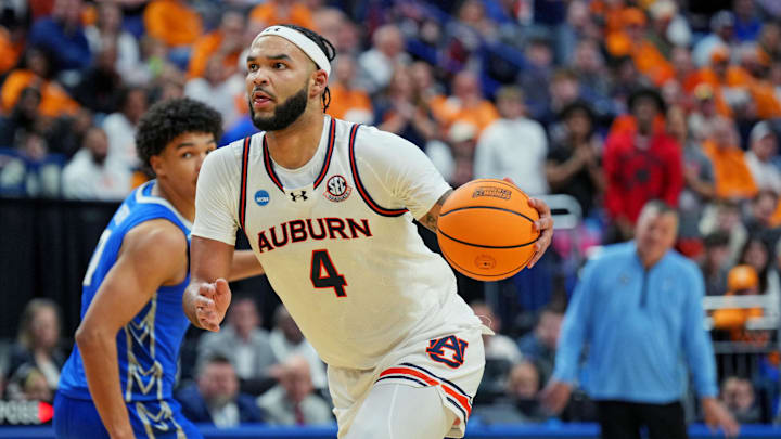 Mar 22, 2025; Lexington, KY, USA;  Auburn Tigers forward Johni Broome (4) drives to the basket against Creighton Bluejays forward Jasen Green (0) during the second half in the second round to the NCAA Tournament at Rupp Arena. Mandatory Credit: Aaron Doster-Imagn Images