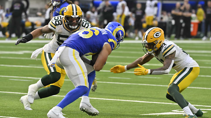 Oct 6, 2024; Inglewood, California, USA; Los Angeles Rams tight end Colby Parkinson (86) is tackled by Green Bay Packers linebacker Isaiah McDuffie (58) and cornerback Eric Stokes (21) during the third quarter at SoFi Stadium. Mandatory Credit: Robert Hanashiro-Imagn Images