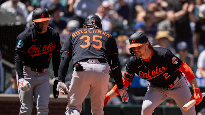 Jun 5, 2025; Seattle, Washington, USA;  Balitimore Orioles designated hitter Adley Rutschman (35) is congratulated by shortstop Gunnar Henderson (2) and second baseman Jackson Holliday (7) after hitting two-run home run during the sixth inning against the Seattle Mariners at T-Mobile Park. 