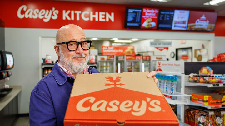 Chef Andrew Zimmern with Casey's BBQ Brisket Pizza