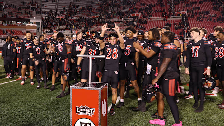The Utah Utes celebrate a win over the Cincinnati Bearcats after the game at Rice-Eccles Stadium.