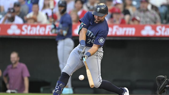 Cal Raleigh #29 of the Seattle Mariners singles in the first inning against the Los Angeles Angels at Angel Stadium in 2024.