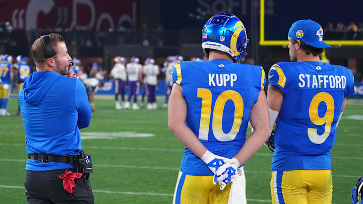Jan 13, 2025; Glendale, AZ, USA; Los Angeles Rams head coach Sean McVay,  quarterback Matthew Stafford (9) and wide receiver Cooper Kupp (10) watch from the sidelines against the Minnesota Vikings during the second half in an NFC wild card game at State Farm Stadium. Mandatory Credit: Joe Camporeale-Imagn Images