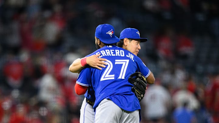 Apr 20, 2026; Anaheim, California, USA; Toronto Blue Jays third baseman Kazuma Okamoto (7) and first baseman Vladimir Guerrero Jr. (27) hug after defeating the Los Angeles Angels at Angel Stadium. Mandatory Credit: William Liang-Imagn Images