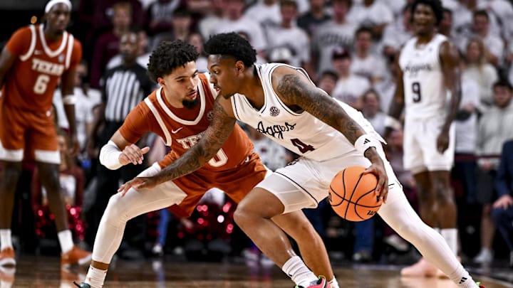 Jan 4, 2025; College Station, Texas, USA; Texas A&M Aggies guard Wade Taylor IV (4) controls the ball as Texas Longhorns guard Jordan Pope (0) defends during the second half at Reed Arena. The Aggies defeated the Longhorns 80-60. Mandatory Credit: Maria Lysaker-Imagn Images 