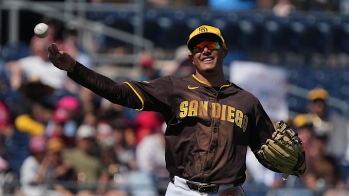 Mar 22, 2025; Peoria, Arizona, USA; San Diego Padres third base Manny Machado (13) makes the play against the Cincinnati Reds in the third inning at Peoria Sports Complex. Mandatory Credit: Rick Scuteri-Imagn Images